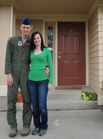 Carlie Doepker, the Enlisted Spouses Club president, poses with her husband Airman 1st Class Jesse Doepker, 92nd Air Refueling Squadron boom operator, in front of their home at Fairchild Air Force Base, Wash., April 30, 2013. The Doepker family has been part of Team Fairchild since August of last year. (U.S. Air Force photo by Airman 1st Class Janelle Patiño/Released)
