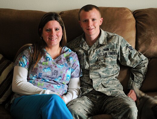 Senior Airman Tyler Bagby, 436th Communications Squadron communications focal point controller, and his wife Stevie Bagby, a volunteer emergency medical technician, pose for a picture April 29, 2013, at their home on Dover Air Force Base, Del. Bagby and his wife helped save two civilians from a burning car on northbound Delaware Route 1 in Dover, Del. (U.S. Air Force photo/Airman 1st Class Ashlin Federick)