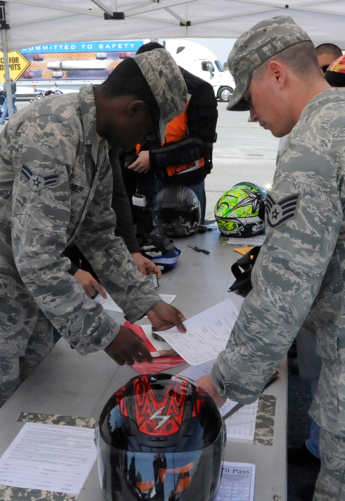 Participants sign waivers to participate in a motorcycle cruise on bikes provided on Motorcycle Safety Day April 26, 2013, Dover Air Force Base, Del. The 436th Airlift Wing Safety team put together the 8th Annual Motorcycle Safety Day to help combat the loss or life and limb for Dover AFB. (U.S. Air Force photo/Senior Airman Jared Duhon)