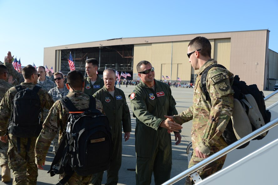 U.S. Air Force Lt. Col. Johnny Vargas, 77th Fighter Squadron commander, shakes the hand of an Airman assigned to the 77th FS at Shaw Air Force Base, S.C., April 25, 2013. More than 400 friends, family members, co-workers and supervisors greeted approximately 100 Airmen assigned to the 77th FS who returned from a six-month deployment in Afghanistan. (U.S. Air Force photo by Master Sgt. Cohen A. Young/Released) 

