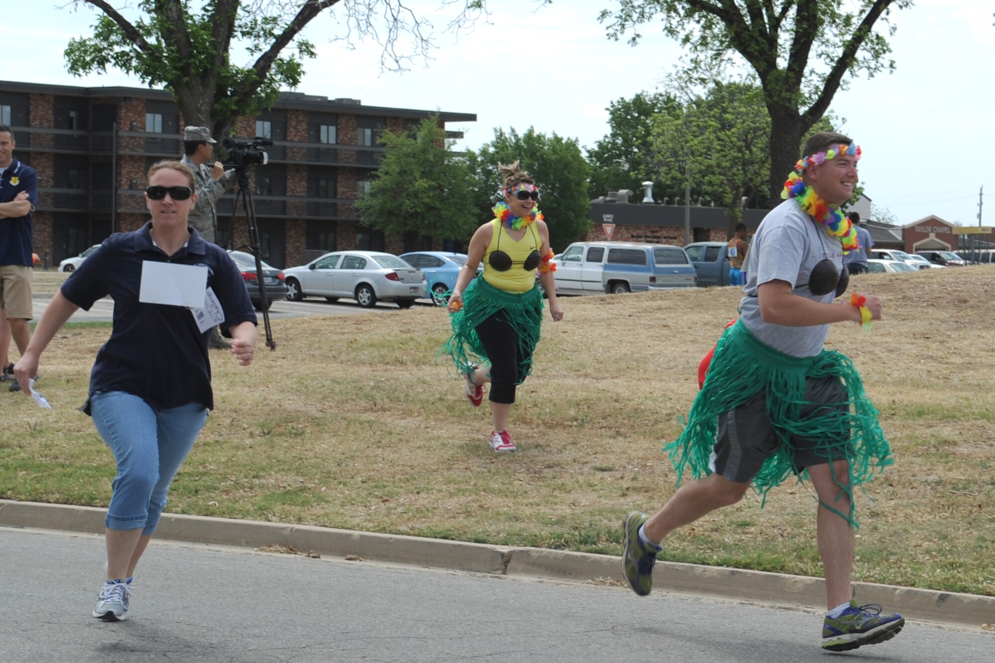GOODFELLOW AIR FORCE BASE, Texas-- Master Sgt. Rachel Taylor, 312th Training Squadron 1st Sergeant., Mary Payton, and 1st Lt. Phillip Trudeau, 17th Civil Engineer Squadron, run to the second task of the 3rd Annual SARC Challenge April 27. The first task had one member of the group search for clues in eggs. (U.S. Air Force photo/Staff Sgt. Laura R. McFarlane)