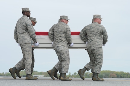 A U.S. Air Force carry team transfers the remains of Staff Sgt. Richard A. Dickson, of Rancho Cordova, Calif., during a dignified transfer April 30, 2013 at Dover Air Force Base, Del. Dickson was assigned to the 306th Intelligence Squadron, Beale AFB, Calif. (U.S. Air Force photo/Greg L. Davis)