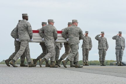 A U.S. Air Force carry team transfers the remains of Capt. Reid K. Nishizuka, of Kailua, Hawaii, during a dignified transfer April 30, 2013 at Dover Air Force Base, Del. Nishizuka was assigned to the 427th Reconnaissance Squadron, Beale AFB, Calif. (U.S. Air Force photo/Greg L. Davis)