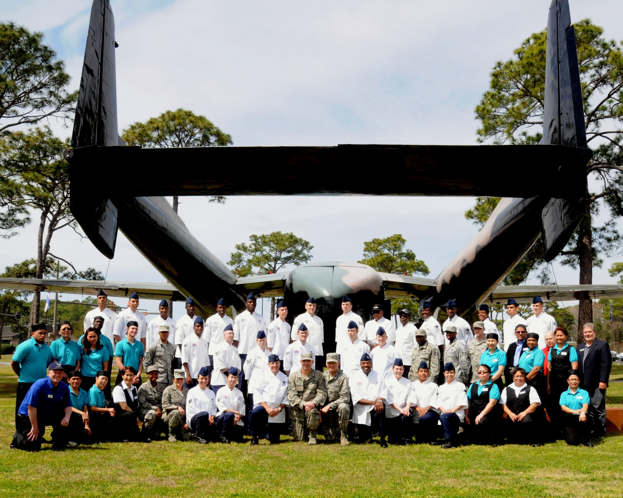 U. S.  Air Force Col. Jim Slife, commander of 1st Special Operations Wing poses in a chef’s jacket for a group photo with the 1st Special Operations Force Support Squadron food services team in celebration of earning the Hennessey Award at Hurlburt Field, Fla., March 28, 2013.  This is the second consecutive year that the Hurlburt Field dining facilities has earned the honor for excellence.  (Courtesy photo by 1st Special Operations Force Support Squadron)