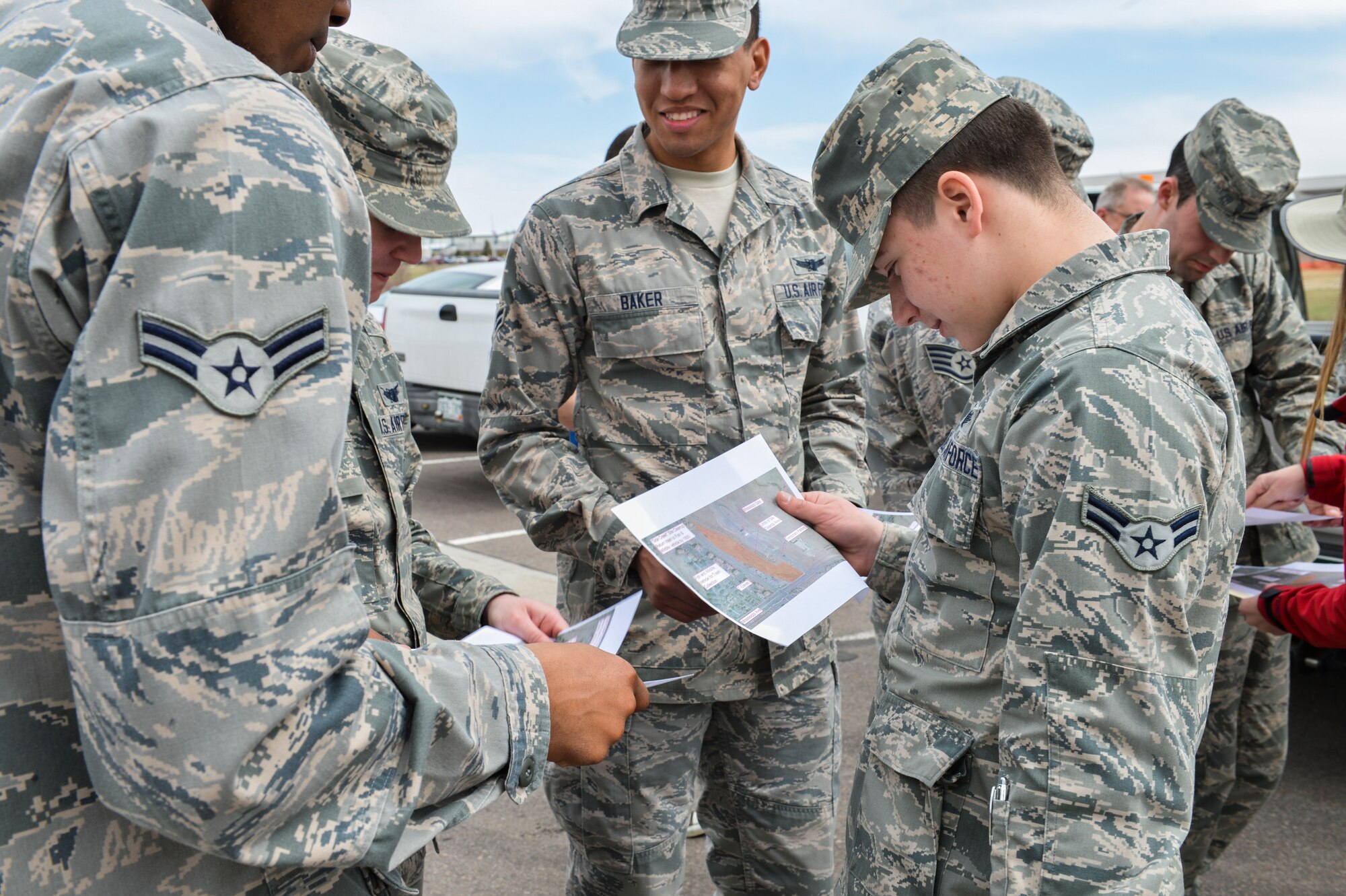 Airman 1st Class Jacob Salinas, right, 2nd Space Warning Squadron space operator, looks over a map of the cleanup route for the Buckley Earth Day site cleanup April 25, 2013, on Buckley Air Force Base, Colo. Each year, Air Force installations worldwide participate in Earth Day by taking actions to enhance sustainability and support the Air Force's Earth Day theme of "Conserve Today - Secure Tomorrow." (U.S. Air Force photo by Senior Airman Paul Labbe/Released)