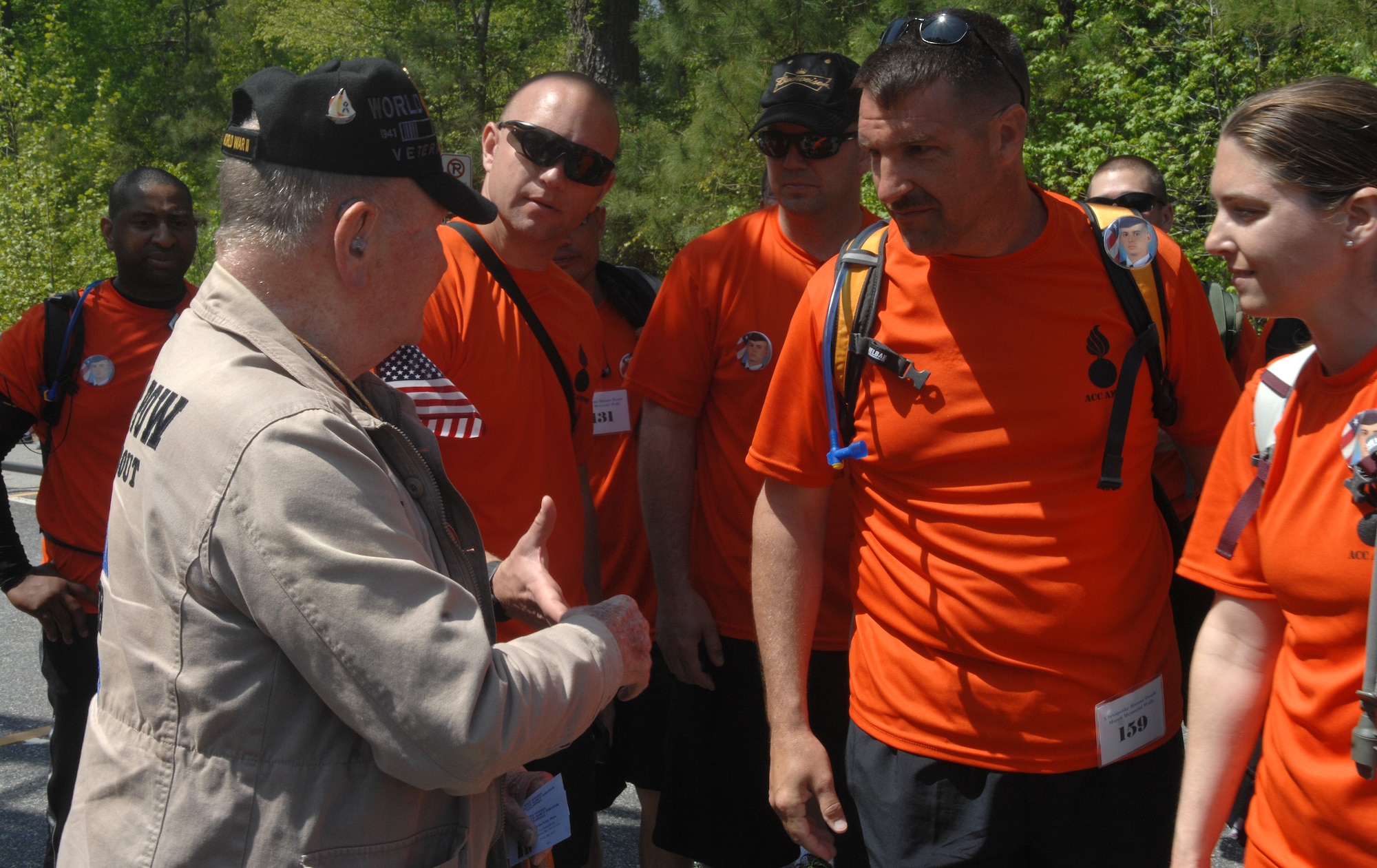 John Mims, a Bataan Death March survivor, thanks Airmen from the 1st Maintenance Squadron ammo shop for walking the Bataan Death March memorial walk at Chesapeake, Va., April 27, 2013. Mims thanked and saluted every participant who passed him towards the end of the 16.6-mile journey. (U.S. Air Force photo by Airman 1st Class Austin Harvill/Released)