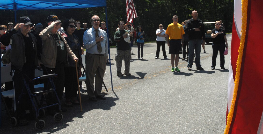 Veterans, event participants and event planners show their respect during the National Anthem after the Bataan Death March memorial walk at Chesapeake, Va., April 27, 2013. During the ceremony after the walk, veterans shared stories from their experience in the original Bataan Death March. (U.S. Air Force photo by Airman 1st Class Austin Harvill/Released)
