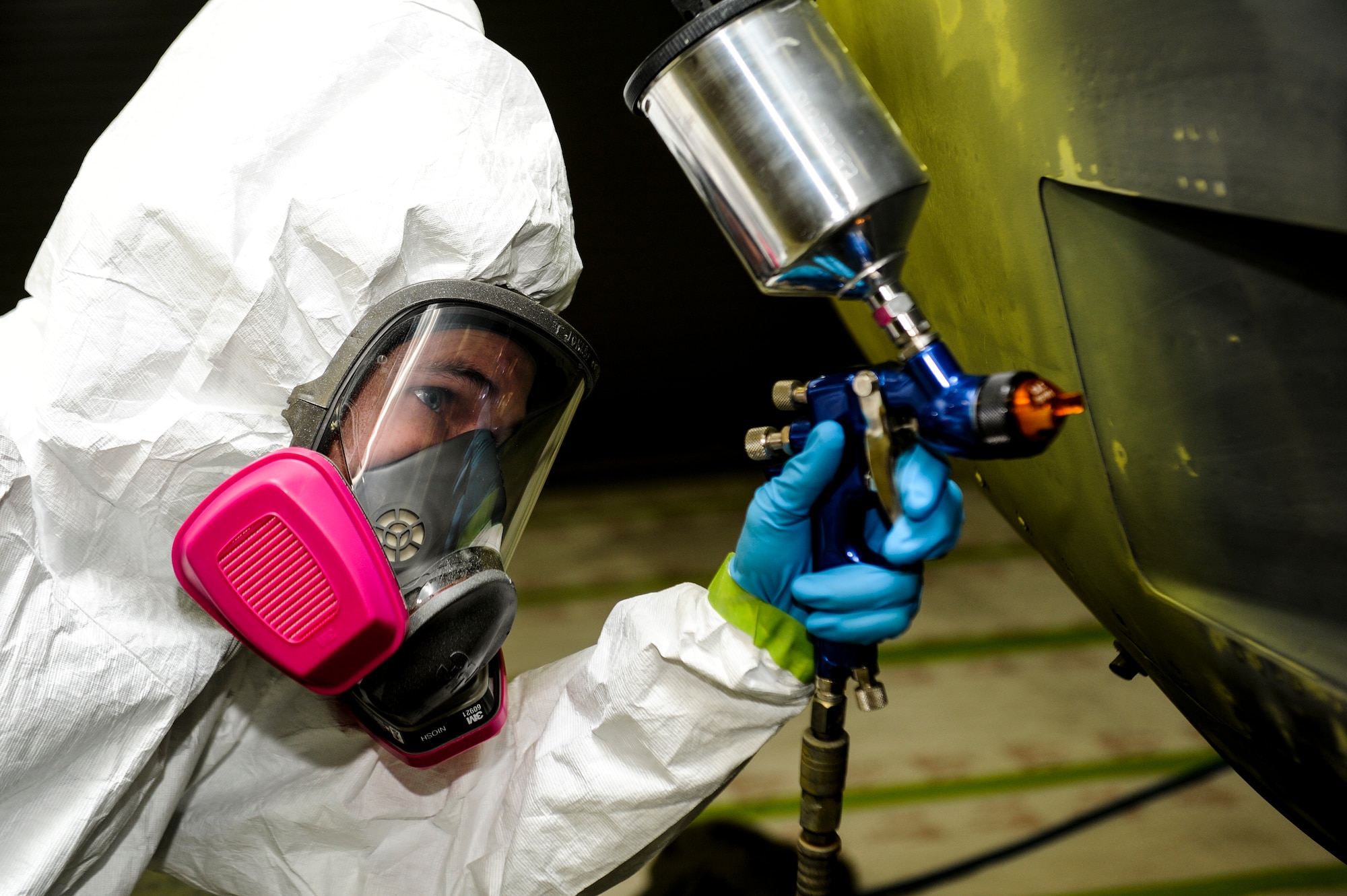 U.S. Air Force Senior Airman Timothy Jones, aircraft structural maintainer from Fabrication Flight, 1st Special Operations Equipment Maintenance Squadron, uses a paint spray gun to add lime green primer to a C-130 engine at the Corrosion Control Facility on Hurlburt Field, Fla., April 25, 2013. The primer is the main source of protection from engine corrosion. (U.S. Air Force photo/Airman 1st Class Christopher Callaway)