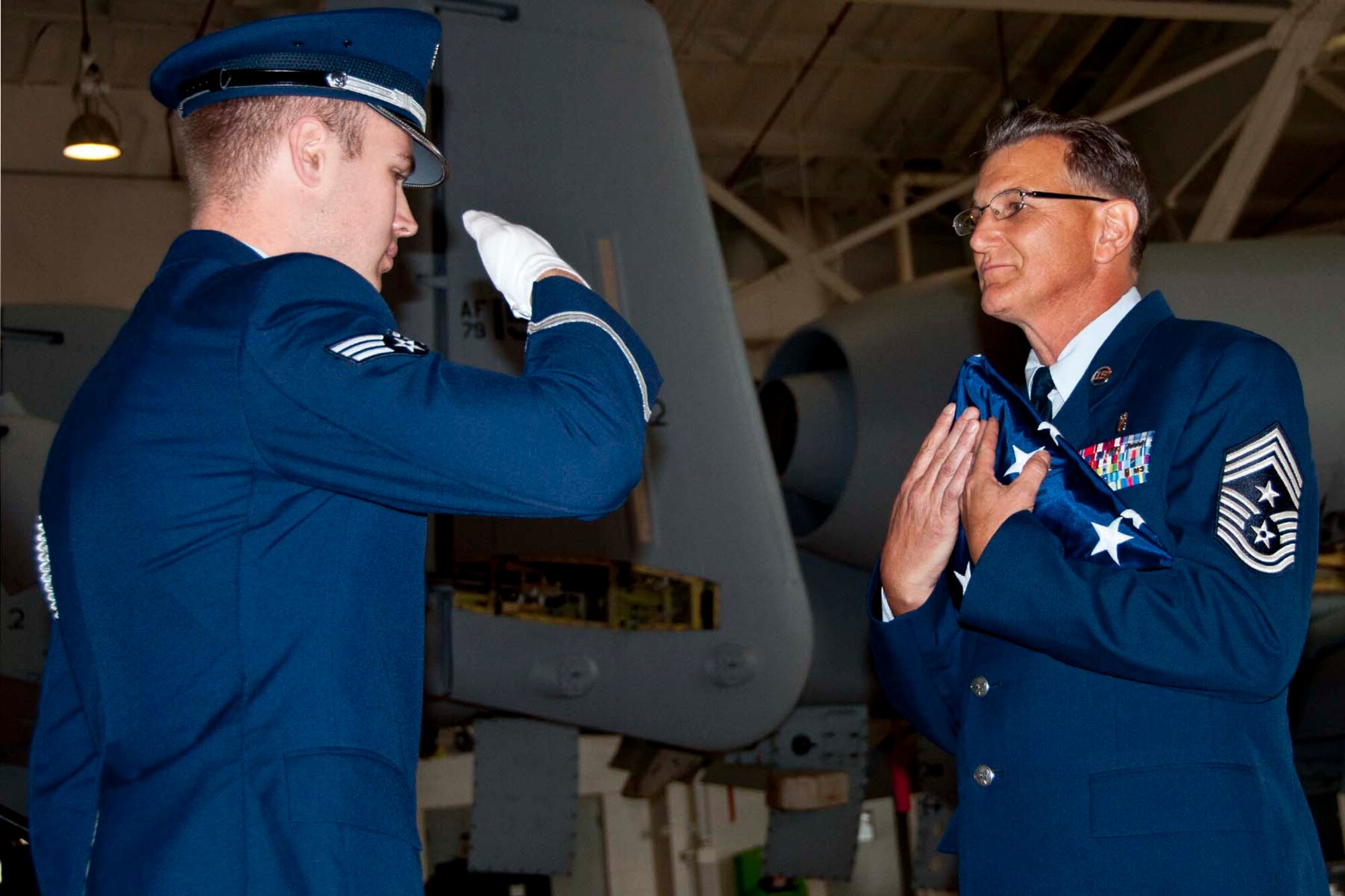 U.S. Air Force Chief Master Sgt. Keith St. Aubin, the 307th Bomb Wing’s Command Chief Master Sgt., accepts a flag during his retirement ceremony at Barksdale Air Force Base, La., April 27, 2013.  A large gathering of family and friends attended the ceremony to wish St. Aubin well during his transition to civilian life.  (U.S. Air Force photo by Tech. Sgt. Ted Daigle/Released)