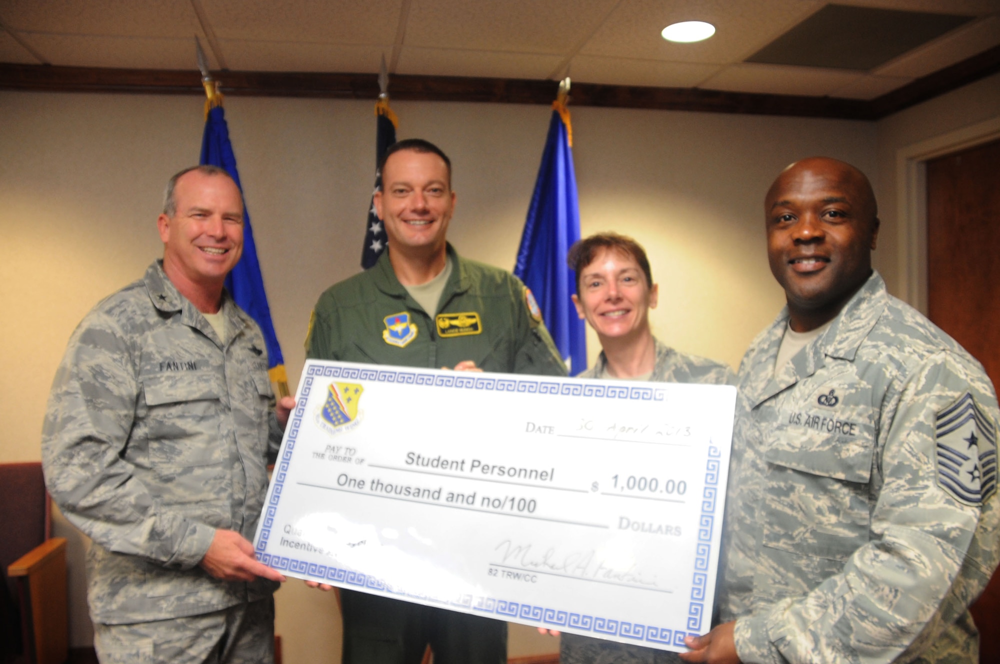 (from left to right) Brig. Gen. Michael Fantini, 82nd Training Wing commander, Col. Lance Bunch, 80th Flying Training Wing commander, Chief Master Sgt. Doreen Losacco, 80th FTW command chief and Chief Master Sgt. Eric Johnson, 82nd TRW command chief celebrate the 80th FTW being named Team Sheppard's student  category winners in the FY13 2nd quarterly recycling awards. (U.S. Air Force photo/Dan Hawkins)