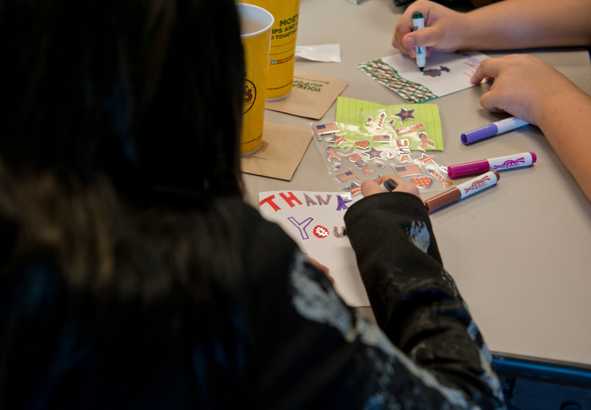 Rori Lewis, age 13, creates a thank you card for deployed troops at the Children in Crisis Clubhouse in Fort Walton Beach, Fla., April 23, 2013. Each child was given a specific job to thank a deployed member for their service.  (U.S. Air Force photo by Senior Airman Krystal M. Garrett) 