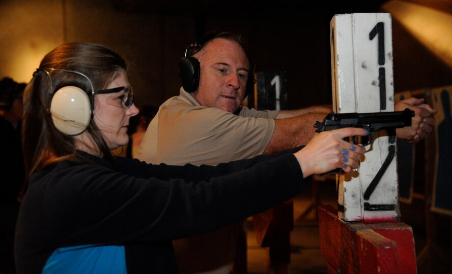 Terry Miguez, 49th Test and Evaluation Squadron, teaches Kelly Walter, spouse of Senior Master Sgt. Matt Walter, Air Force Global Strike Command, the proper firing stance during the Women's Introduction to Firearms class on Barksdale Air Force Base, La., April 26, 2013. A total of 10 women attended the class to learn more about handguns in case they run into a situation where they may have to use one. (U.S. Air Force photo/Airman 1st Class Andrew Moua)