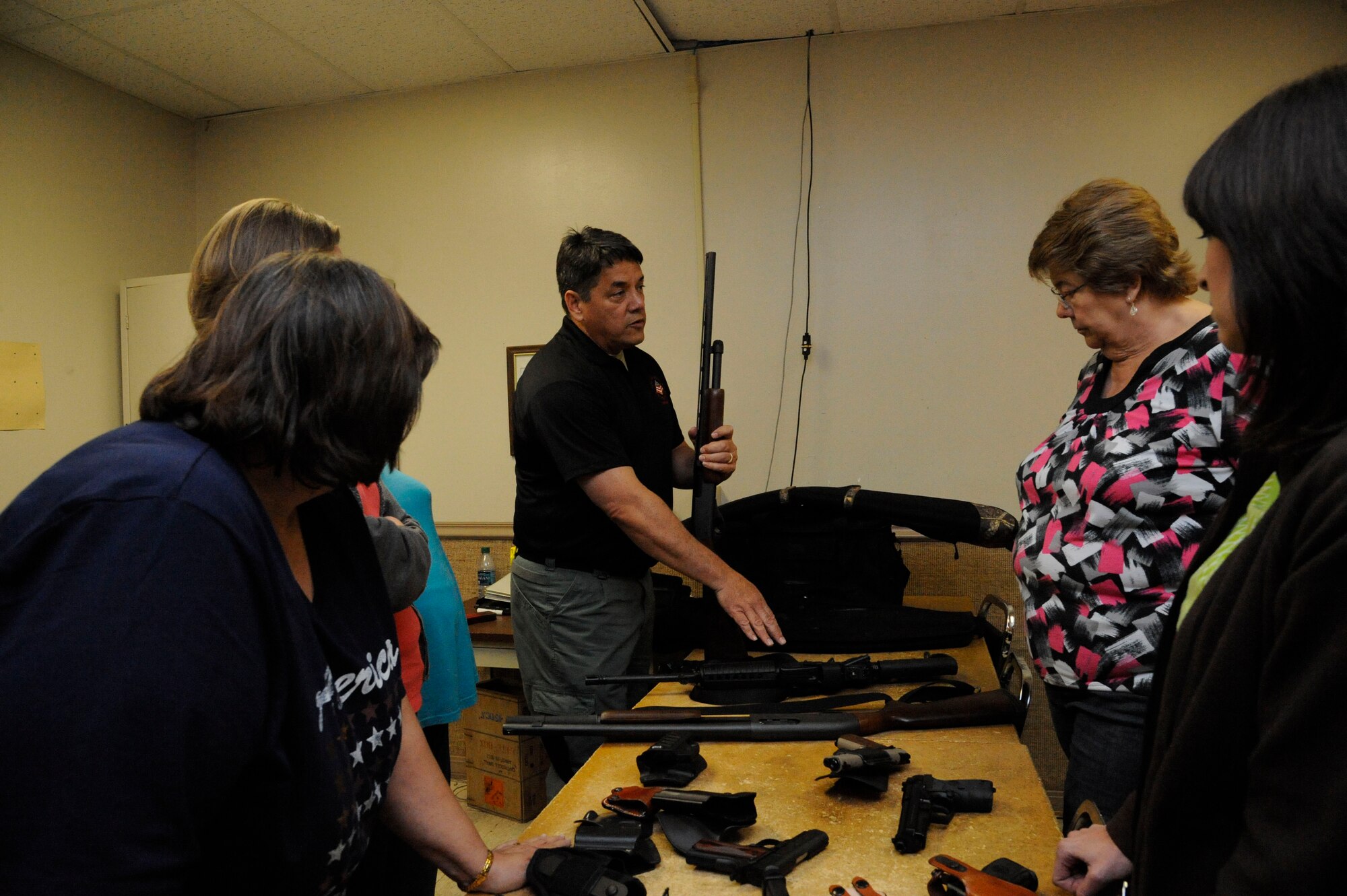 Air Force Reserve Master Sgt. John Reser, 2nd Bomb Wing Safety Office, instructs students of the Women's Introduction to Firearms class on various firearms on Barksdale Air Force Base, La., April 26, 2013. The class sought to educate and familiarize women with firearms so they can protect themselves in case they may need to use one. (U.S. Air Force photo/Airman 1st Class Andrew Moua)