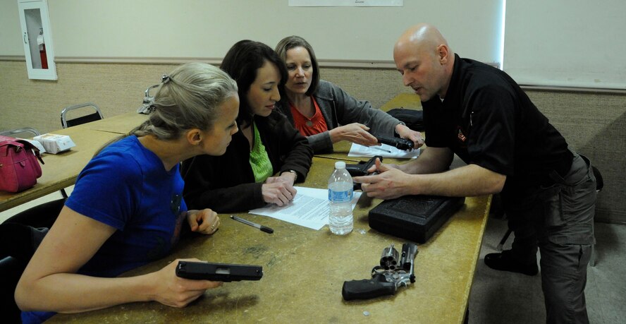 Peter Desjardin, Air Force Global Strike Command, teaches students of the Women's Introduction to Firearms class how to operate a handgun on Barksdale Air Force Base, La., April 26, 2013. A total of 10 women attended the class to learn more about handguns in case they run into a situation where they may have to use one. (U.S. Air Force photo/Airman 1st Class Andrew Moua)