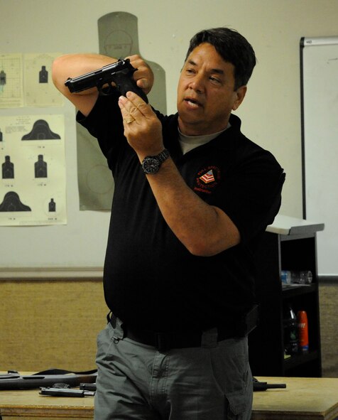 Air Force Reserve Master Sgt. John Reser, 2nd Bomb Wing Safety Office, instructs students of the Women's Introduction to Firearms class on the different parts of a handgun on Barksdale Air Force Base, La., April 26, 2013. The class sought to educate and familiarize women with firearms so they can protect themselves in case they may need to use one. (U.S. Air Force photo/Airman 1st Class Andrew Moua)