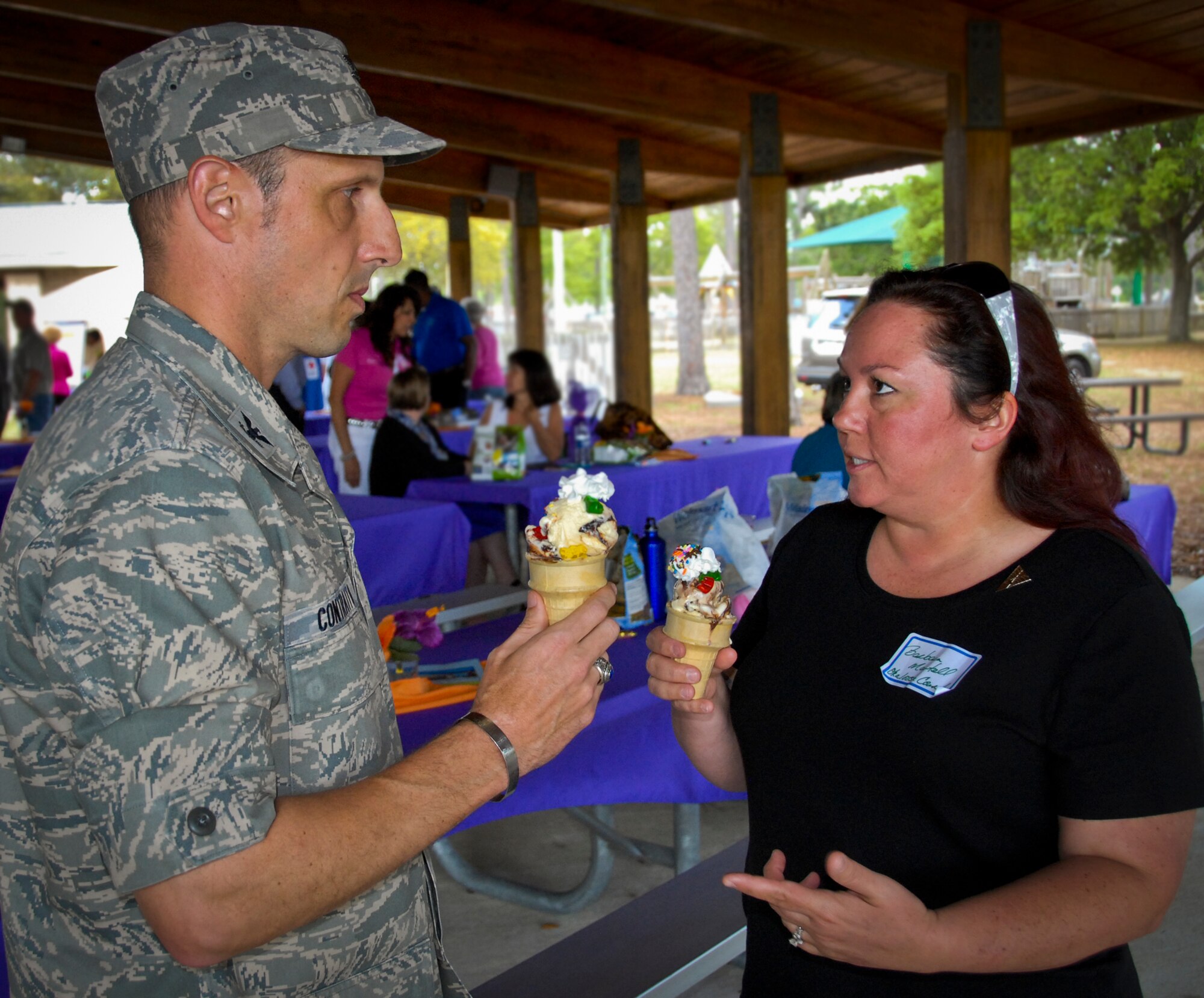 Barbara Martell, Eglin Hospital, and Col. Michael Contratto, the 96th Test Wing operations vice-commander, enjoy ice cream cones following an awards ceremony at the Volunteer Appreciation Ice Cream Social April 25 at Eglin Air Force Base, Fla. Along with Martell, the other recipients were Dotty Blacker, Eglin Natural Resources, Jackson Guard; Lenny Fenimore, Eglin Natural Resources, Jackson Guard and Jeffery Kern, Boy Scouts of America, Gulf Coast Council.  The volunteers were recognized for their efforts in the military and local communities. (U.S. Air Force photo/Kevin Gaddie)