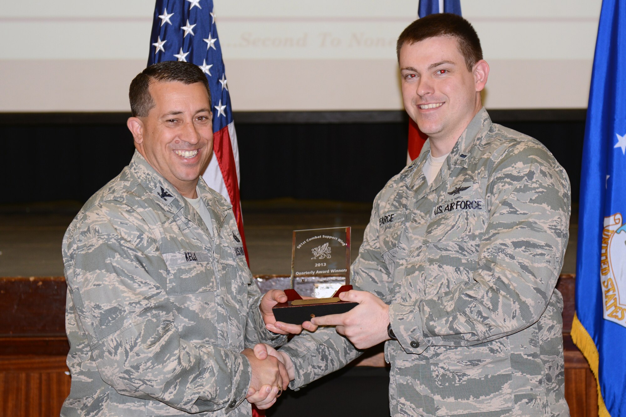 RAF ALCONBURY, United Kingdom – First Lt. Kyle Pearce, 422nd Communications Squadron, accepts the 501st CSW Airman award for the first quarter from Col. Brian Kelly, 501st Combat Support Wing commander, on behalf of Senior Airman Richard Stokes, 422nd CS, April 22. (U.S. Air Force photo by Tech. Sgt. Chrissy Best)