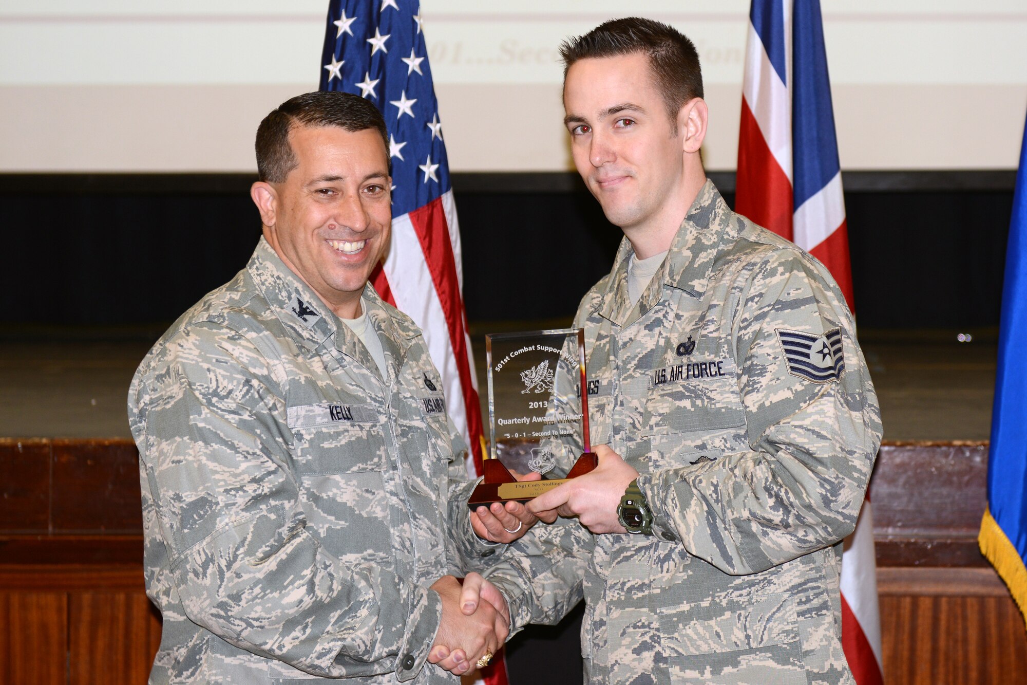 RAF ALCONBURY, United Kingdom – Tech. Sgt. Cody Stollings, 422nd Security Forces Squadron, accepts the 501st CSW Honor Guard award for the first quarter from Col. Brian Kelly, 501st Combat Support Wing commander, April 22. (U.S. Air Force photo by Tech. Sgt. Chrissy Best)