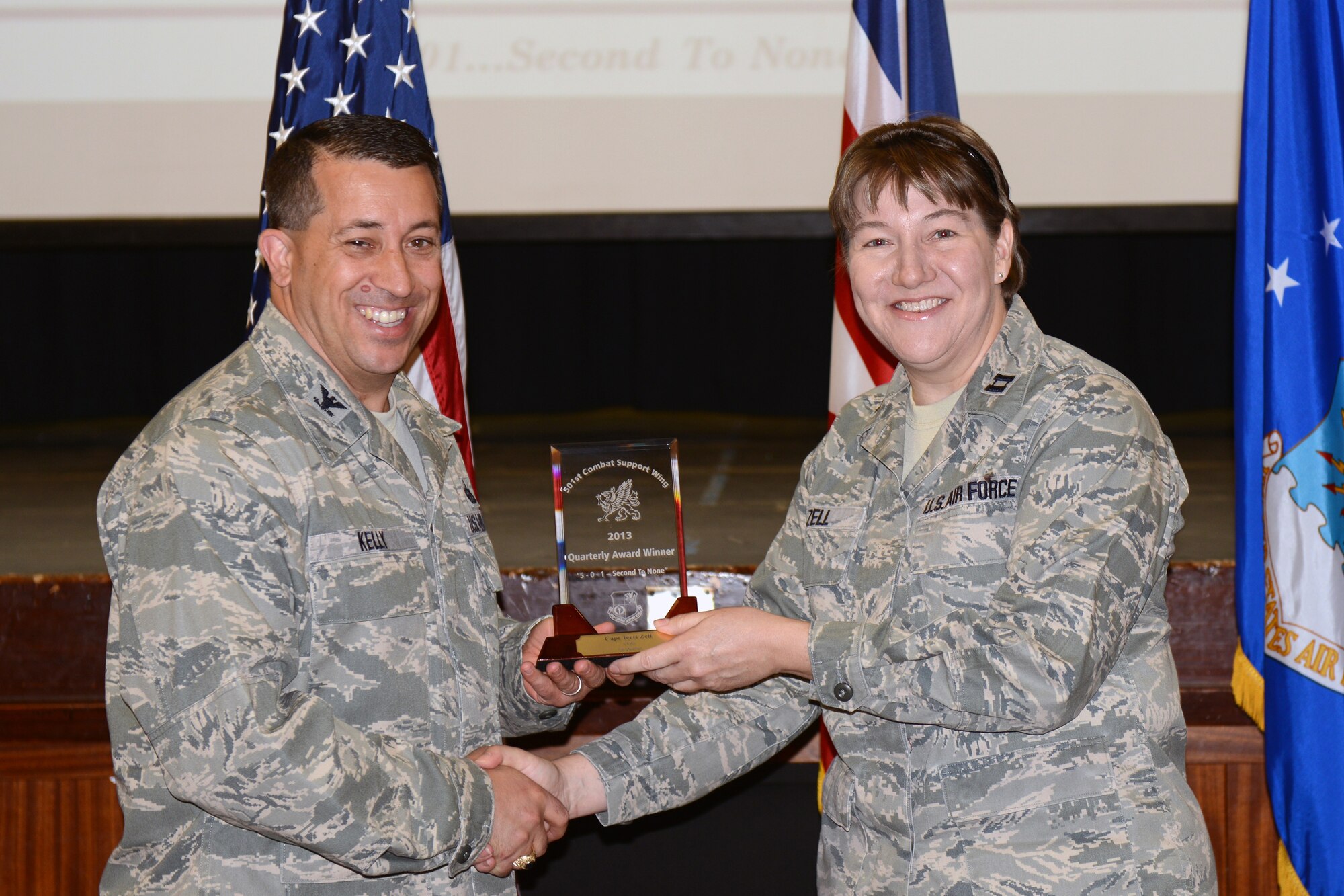 RAF ALCONBURY, United Kingdom – Capt. Terri Zell, 422nd Medical Squadron, accepts the 501st CSW Honor Guard award for the first quarter from Col. Brian Kelly, 501st Combat Support Wing commander, April 22. (U.S. Air Force photo by Tech. Sgt. Chrissy Best)