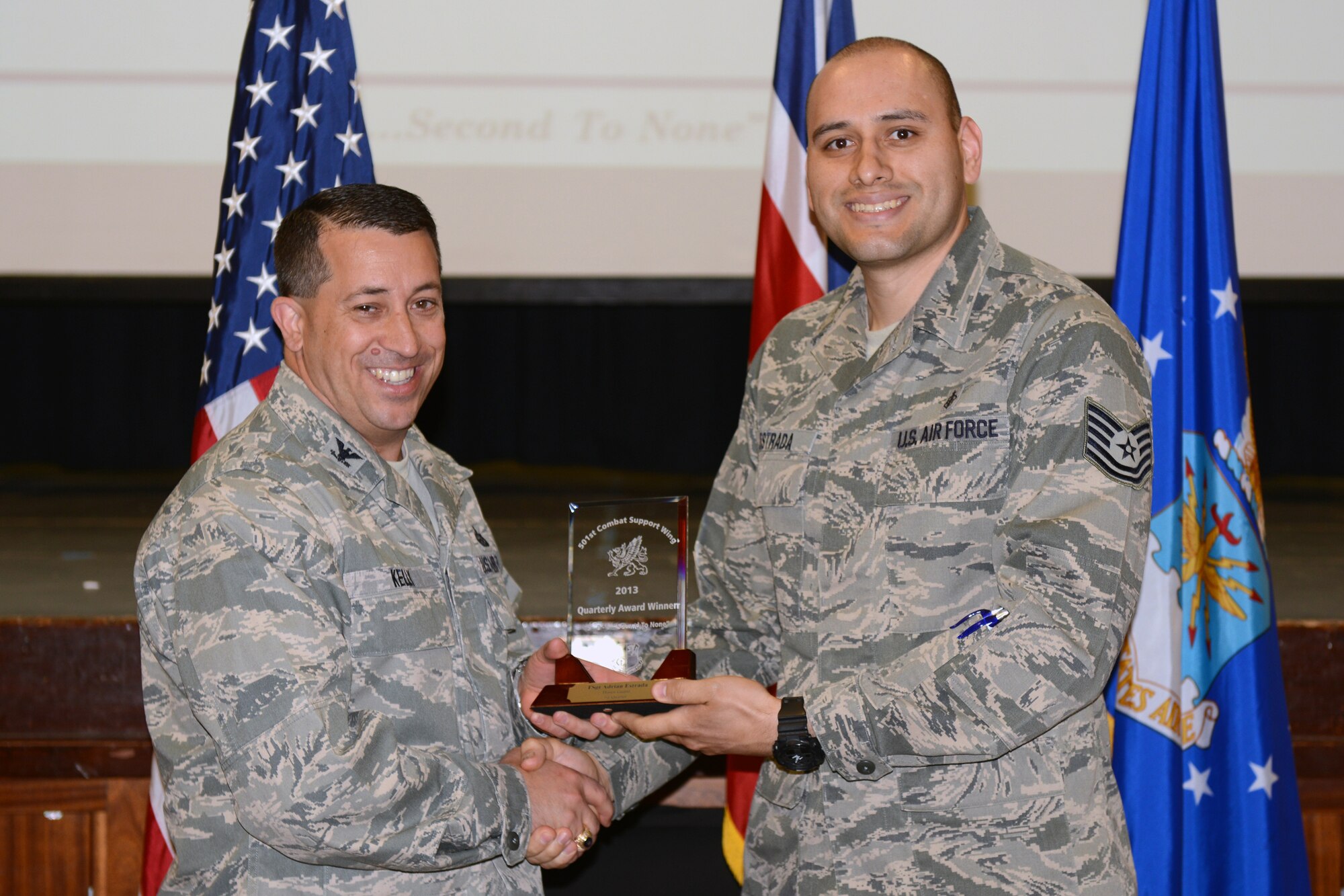 RAF ALCONBURY, United Kingdom – Tech. Sgt. Adrian Estrada, 422nd Medical Squadron, accepts the 501st CSW Honor Guard award for the first quarter from Col. Brian Kelly, 501st Combat Support Wing commander, April 22. (U.S. Air Force photo by Tech. Sgt. Chrissy Best)
