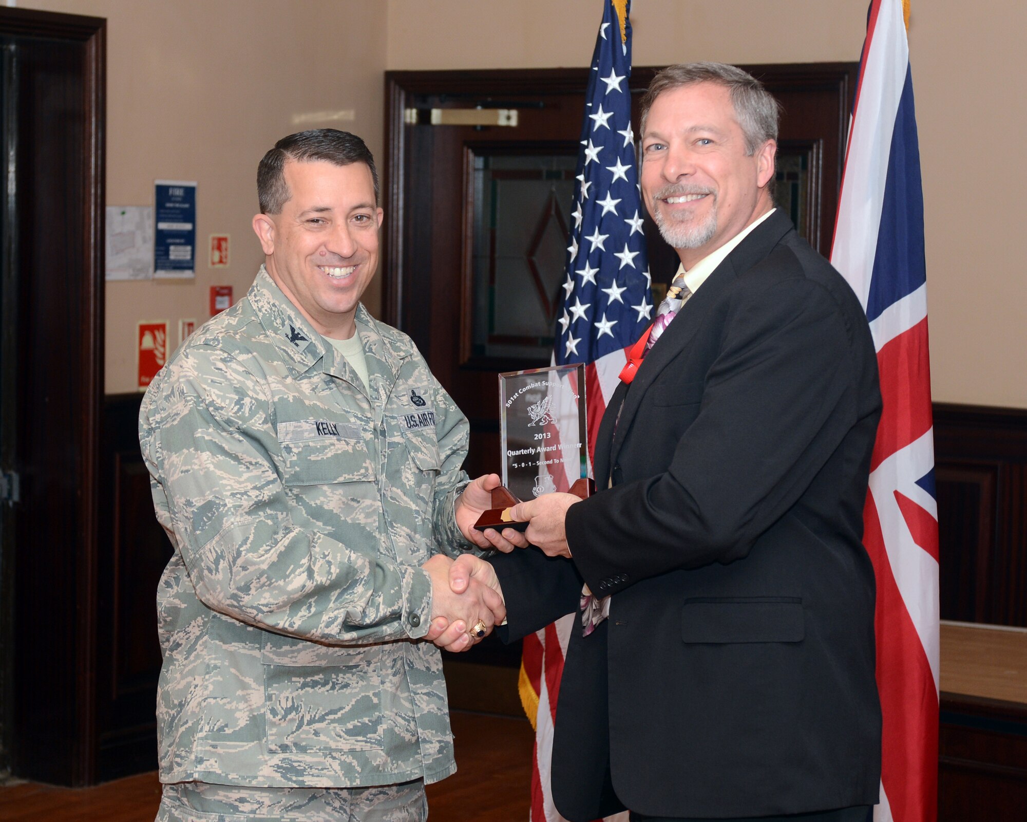 RAF MENWITH HILL, United Kingdom – David LaPlante, 421st Civil Engineer Squadron, accepts the 501st CSW Civilian Category II award for the first quarter from Col. Brian Kelly, 501st Combat Support Wing commander, April 23. (U.S. Air Force photo by Staff Sgt. Debbie Lockhart)