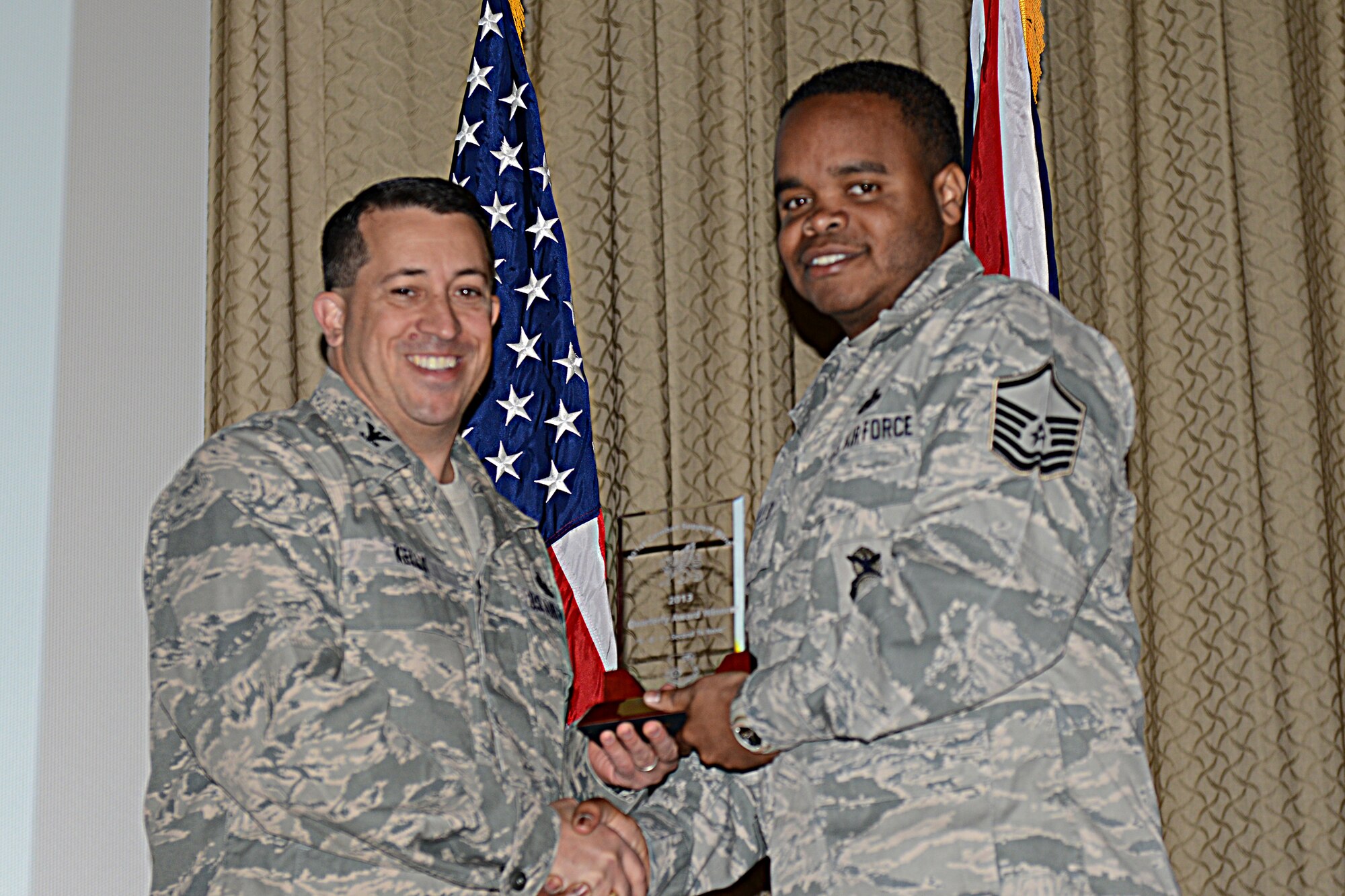 RAF ALCONBURY, United Kingdom – Master Sgt. Cleophus Gallon, 423rd Security Forces Squadron, accepts the 501st CSW Senior NCO award for the first quarter from Col. Brian Kelly, 501st Combat Support Wing commander, April 24. (U.S. Air Force photo by Tech. Sgt. Chrissy Best)