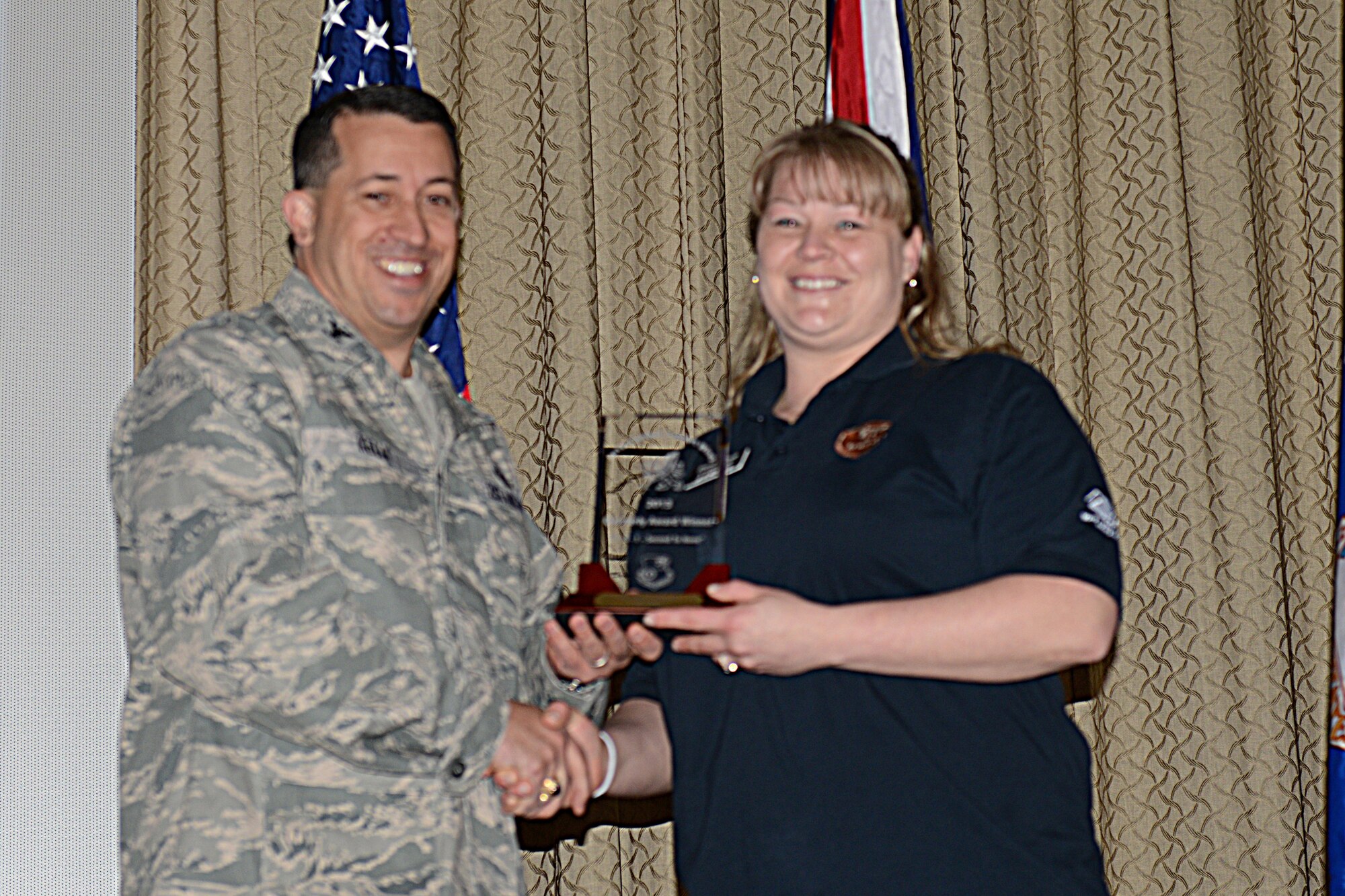 RAF ALCONBURY, United Kingdom – Sheila Pietrylo, 423rd Force Support Squadron, accepts the 501st CSW Civilian Category I award for the first quarter from Col. Brian Kelly, 501st Combat Support Wing commander, April 24. (U.S. Air Force photo by Tech. Sgt. Chrissy Best)