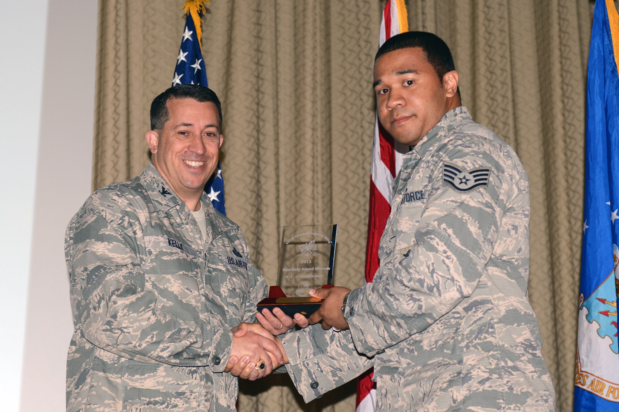 RAF ALCONBURY, United Kingdom – Staff Sgt. Jeffrey Evans, 423rd Security Forces Squadron, accepts the 501st CSW Military Volunteer award for the first quarter from Col. Brian Kelly, 501st Combat Support Wing commander, April 24. (U.S. Air Force photo by Tech. Sgt. Chrissy Best)