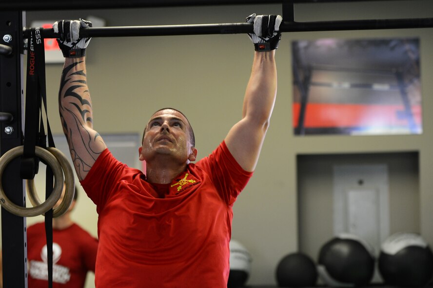 U.S. Army Maj. Jay Valesco, U.S. Army Central targeting officer, does a pull-up at a local gym, Sumter, S.C., April 27, 2013.  A workout named "The Mano," was held to commemorate the life of Capt. James "Mano" Steel, 77th Fighter Squadron pilot, who died as a result of an F-16 Fighting Falcon accident in Afghanistan. (U.S. Air Force photo by Airman 1st Class Nicole Sikorski/Released)