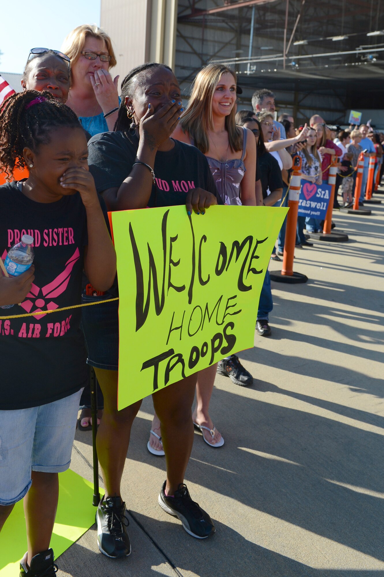 Komiya Johnson, the mother of Airman 1st Class Tyrek Johnson, 77th Fighter Squadron weapons crewman, and other members of his family cry as the plane with members of the 77th FS lands at Shaw Air Force Base, S.C., April 25, 2013. Johnson and approximately 100 other Airmen from the squadron were returning after a six month deployment to Afghanistan. About 400 family members and friends welcomed the members of the squadron home. (U.S. Air Force photo by Airman 1st Class Krystal M. Jeffers/Released)