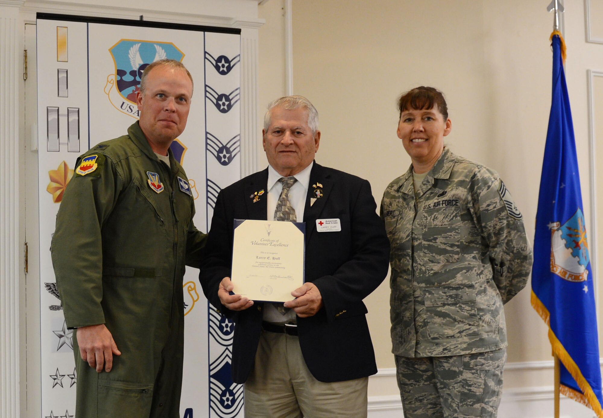 U.S. Air Force Col. Lance Kildron, 20th Fighter Wing vice commander, and Chief Master Sgt. Suzanne Talbert, 20th Mission Support Group superintendent, present the certificate for volunteer excellence to Larry Huff, 20th Medical Support Squadron American Red Cross station chairman, at Carolina Skies Club and Conference Center, Shaw Air Force Base, S.C., April 22, 2013. The 20th FW hosted the breakfast to recognize volunteers for their selfless acts in volunteering. (U.S. Air Force photo by Senior Airman Tabatha Zarrella/Released)
