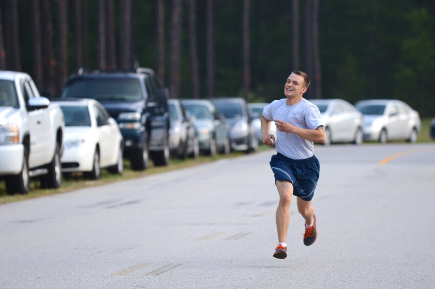 Senior Airman Kevin Dobson, 20th Civil Engineer Squadron, heating, ventilation and air-conditioning technician, finishes first during a sexual assault prevention run at the Fitness Center Annex, Shaw Air Force Base, S.C., April 26, 2013.  The three-mile run had more than 300 participants and kicked off the 20th Fighter Wing’s Comprehensive Airmen Fitness Day.  (U.S. Air Force photo by Airman 1st Class Nicole Sikorski/Released)