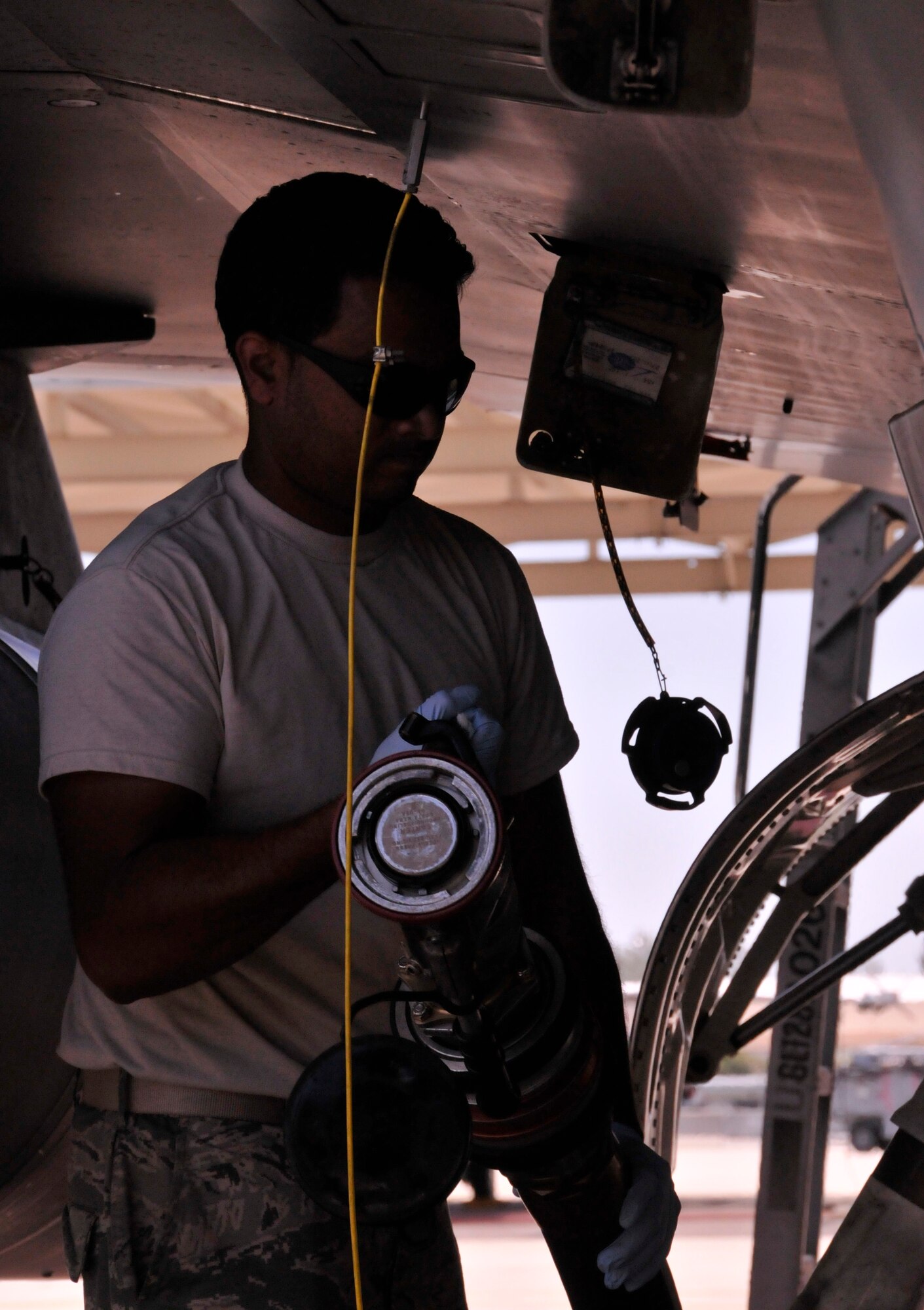 Tech. Sgt. Brijesh Seepersad, 482nd Aircraft Maintenance Squadron crew chief, removes fuel nozzle after an F-16 refueling at Homestead Air Reserve Base, Fla., April 26. (U.S. Air Force photo/Senior Airman Jaimi Upthegrove)