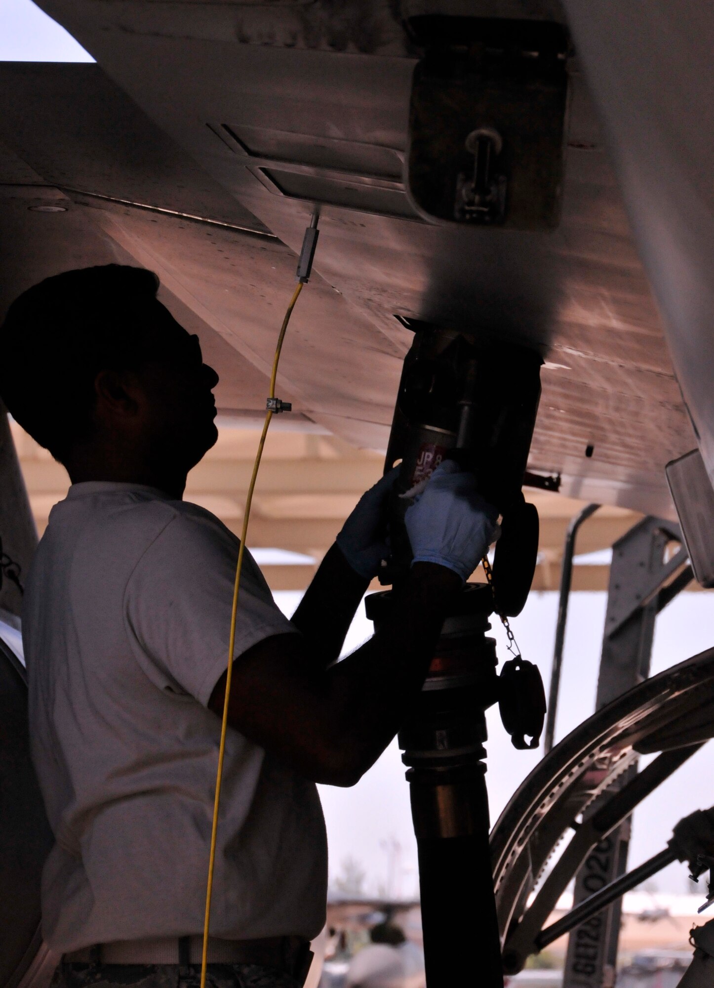 Tech.  Sgt. Brijesh Seepersad, 482nd Aircraft Maintenance Squadron crew chief, attaches the fuel nozzle to an F-16 for fuel transfer at Homestead Air Reserve Base, Fla., April 26. (U.S. Air Force photo/Senior Airman Jaimi Upthegrove)