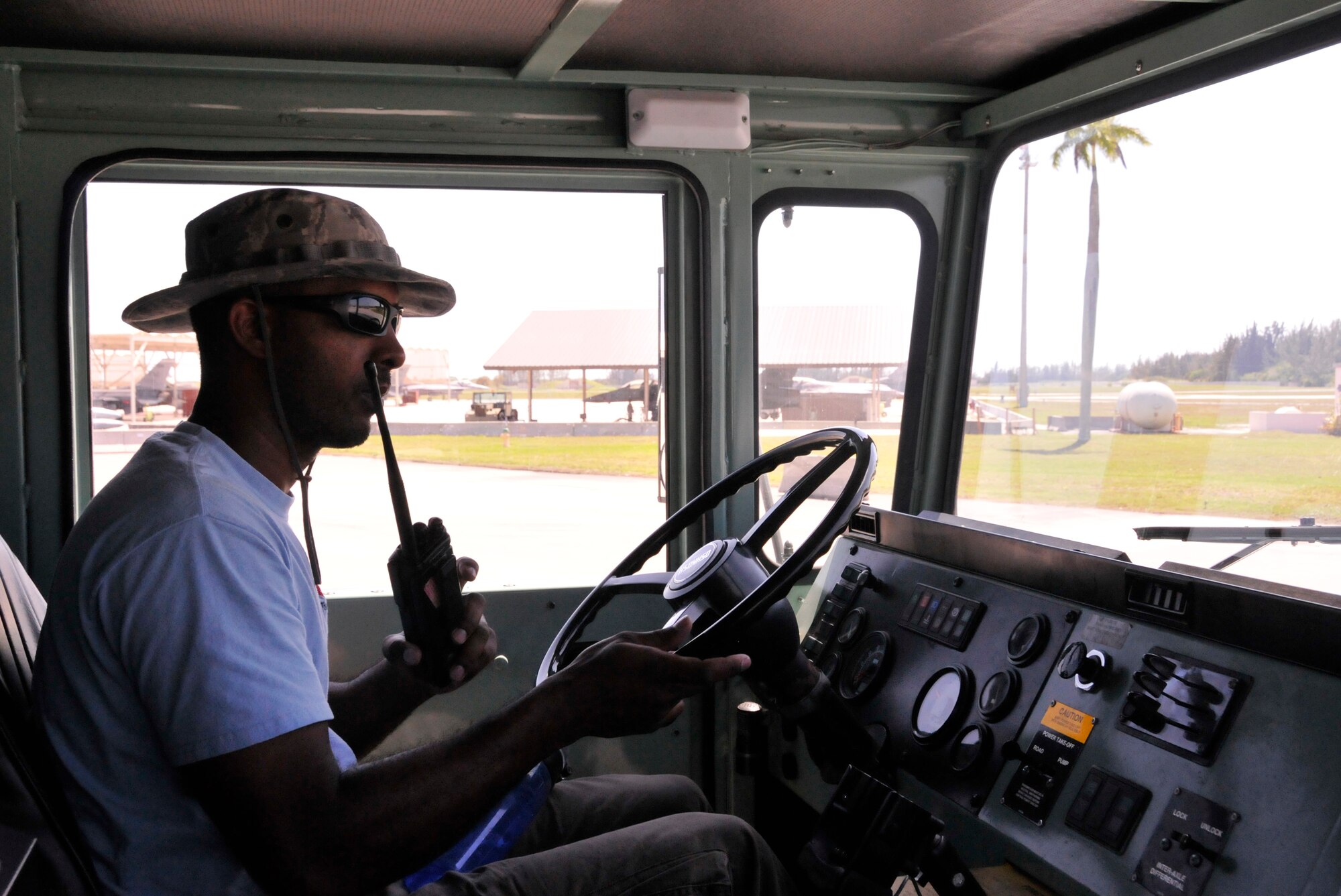 Oliver Gibbs, 482nd Logistics Readiness Squadron fuels distribution specialist, drives a fuel truck across the flight line as he radios the air traffic control tower to obtain clearance to drive on the flight-line at Homestead Air Reserve Base, Fla., April 26.  (U.S. Air Force photo/Senior Airman Jaimi Upthegrove)
