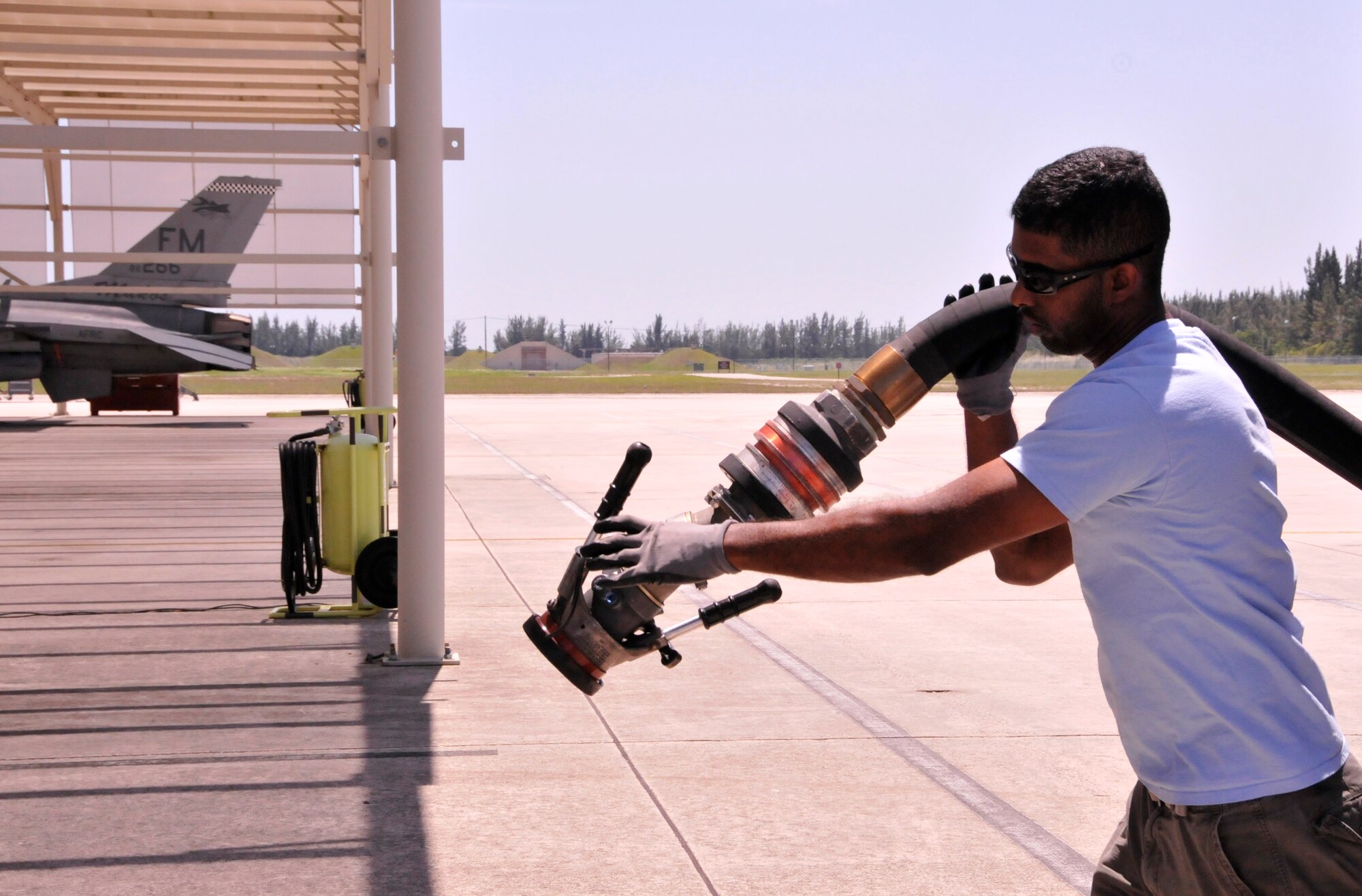 Oliver Gibbs, 482nd Logistics Readiness Squadron fuels distribution specialist, readies a hose to refuel an F-16 at Homestead Air Reserve Base, Fla., April 26. (U.S. Air Force photo/Senior Airman Jaimi Upthegrove)