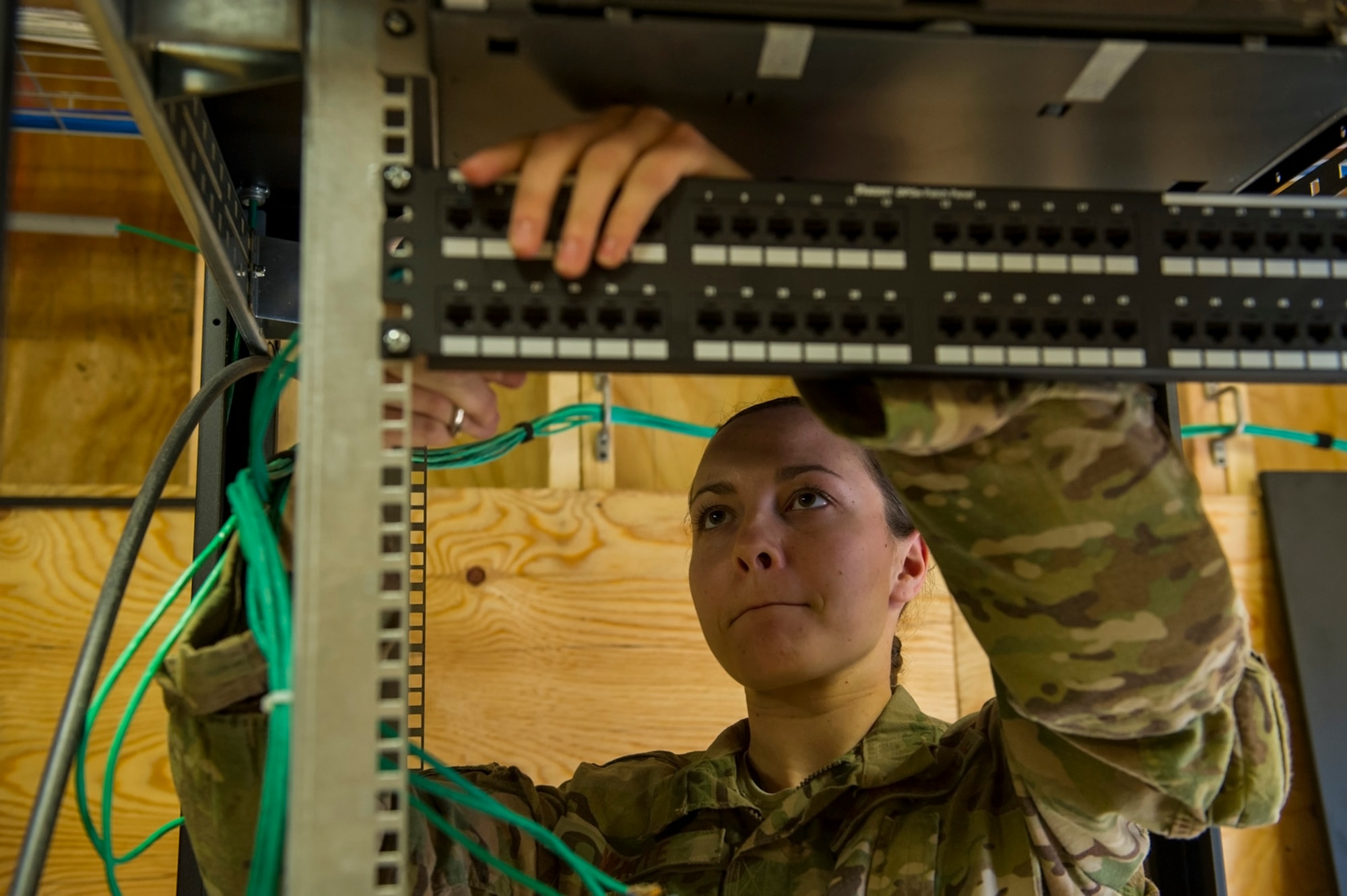 U.S. Air Force Senior Airman Tarah White, 160th Theater Signal Support Brigade airfield systems journeyman, punches down category five cable to a patch panel, March 19, 2013, at Bagram Airfield, Afghanistan. White is a member of an Air National Guard Engineering & Installation Team deployed from the 219th Engineering Installation Squadron, Tulsa, Oklahoma. White is a native of Greeley, Colorado. (U.S. Air Force photo by Staff Sgt. Marleah Miller)