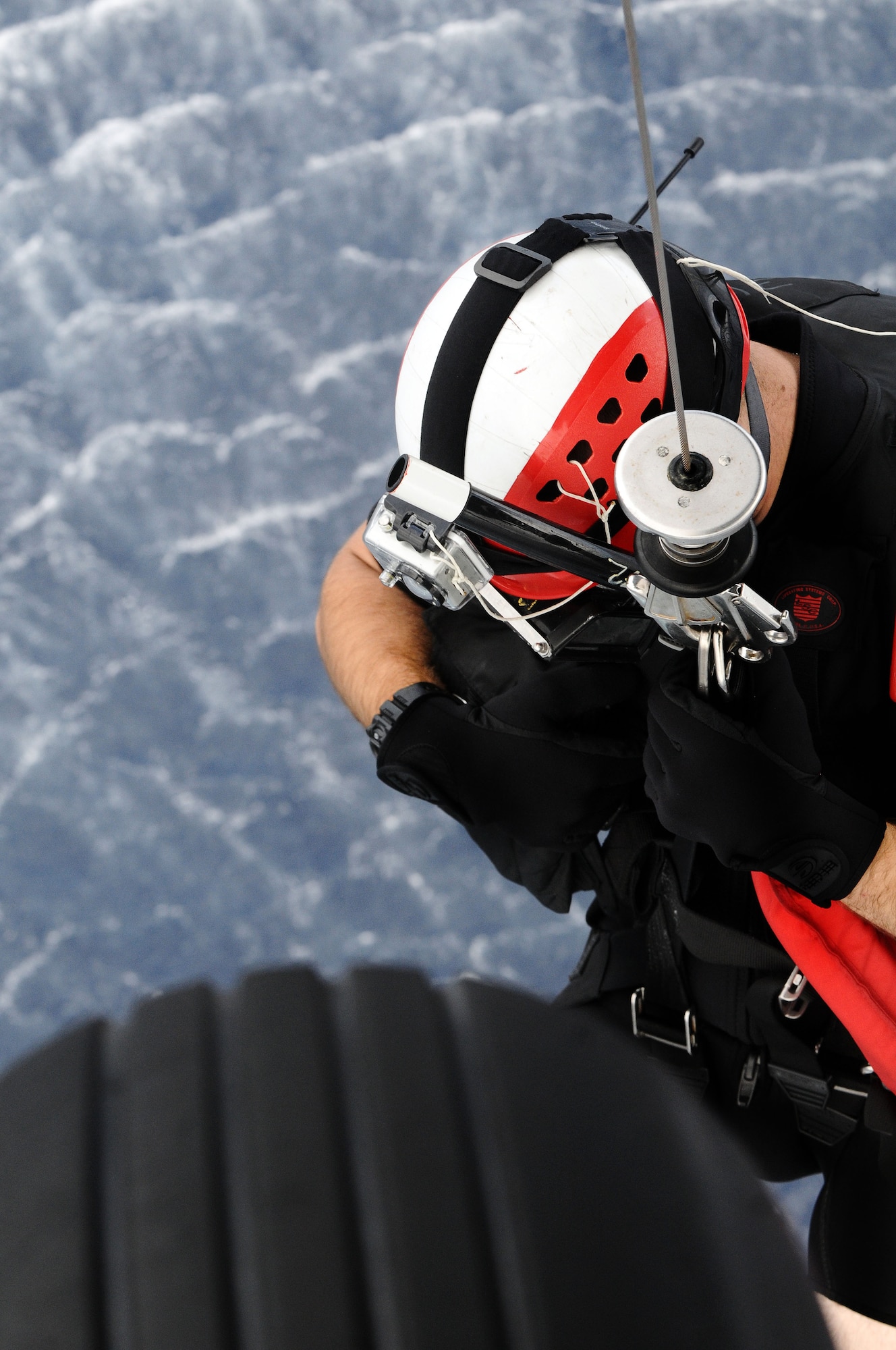 Petty Officer 3rd Class Kurtis Istre, Helicopter Sea Combat Squadron 25 aircrewman, is lowered into the ocean during joint training at Sirena Beach on Andersen Air Force Base, Guam, April 25, 2013.