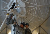U.S. Air Force Staff Sgt. David Linn and Senior Airman William Amarillo, 18th Communications Squadron radio frequency transmissions technicians, conduct routine maintenance on one of the meteorological weather antenna on Kadena Air Base, Japan,  April 24, 2013. The radio frequency transmissions shop maintains four Mark4B antennas, which help weather forecasters keep up-to-date satellite information for forecasting purposes. (U.S. Air Force photo by Staff Sgt. Lauren Snyder/Released)