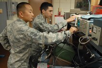 U.S. Air Force Senior Airmen Nathaniel Lee and William Amarillo, 18th Communications Squadron radio frequency transmissions technicians, measure modulation on a multiband handheld troop radio, commonly known as a brick, on Kadena Air Base, Japan,  April 24, 2013. If a radio is out of modulation, the range is significantly reduced and personnel could not talk to other aircraft or personnel during operations. (U.S. Air Force photo by Staff Sgt. Lauren Snyder/Released)