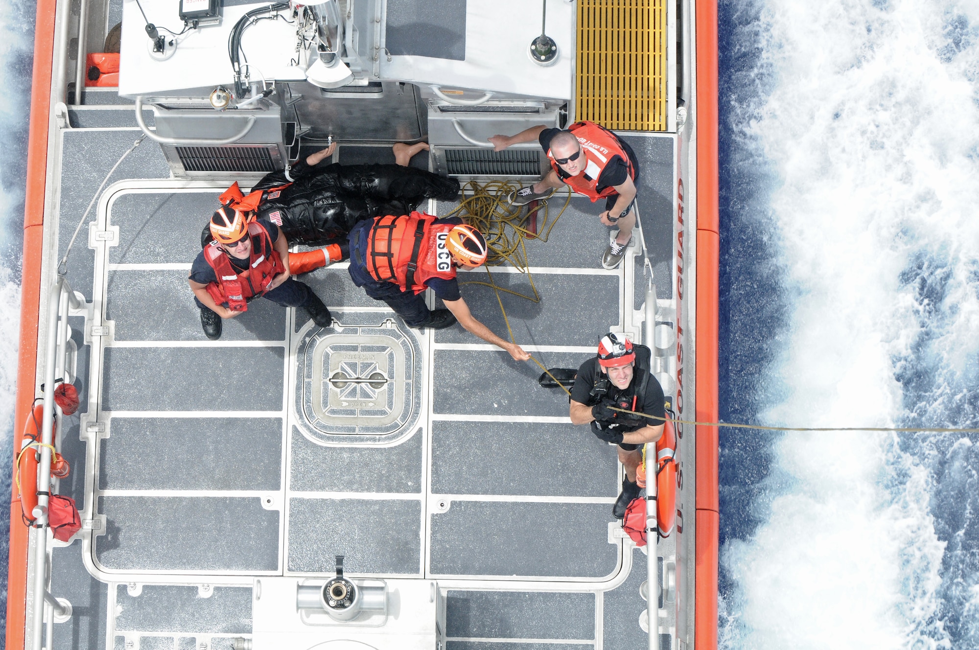 Petty Officer 3rd Class Kurtis Istre, Helicopter Sea Combat Squadron 25 aircrewman, assists the U.S. Coast Guard during joint training at Sirena Beach on Andersen Air Force Base, Guam, April 25, 2013. 