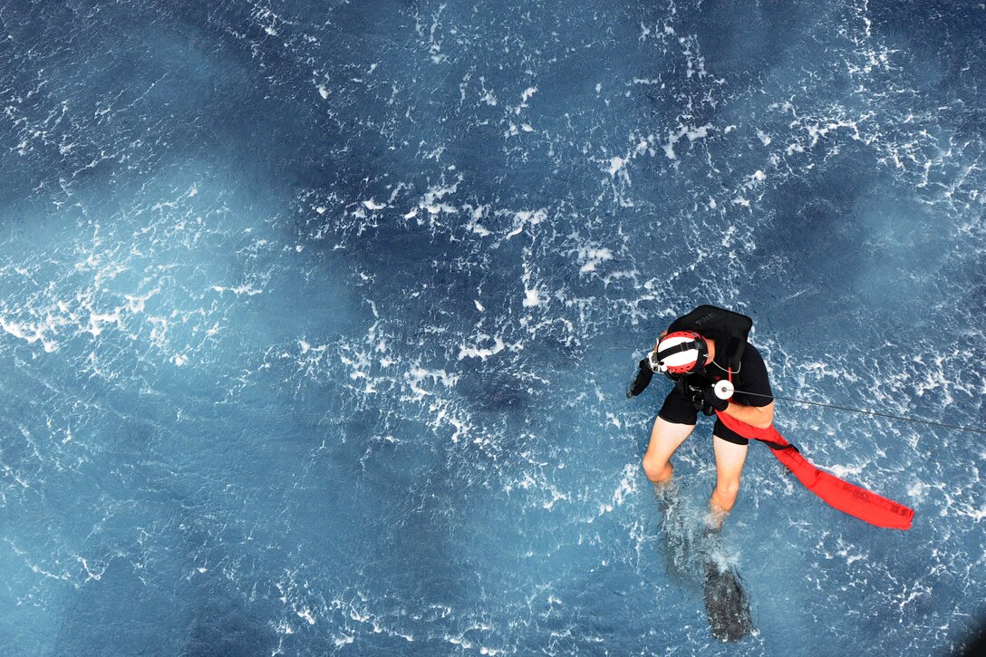 Petty Officer 3rd Class Kurtis Istre, Helicopter Sea Combat Squadron 25 aircrewman, is lowered into the ocean during joint training at Sirena Beach on Andersen Air Force Base, Guam, April 25, 2013. 