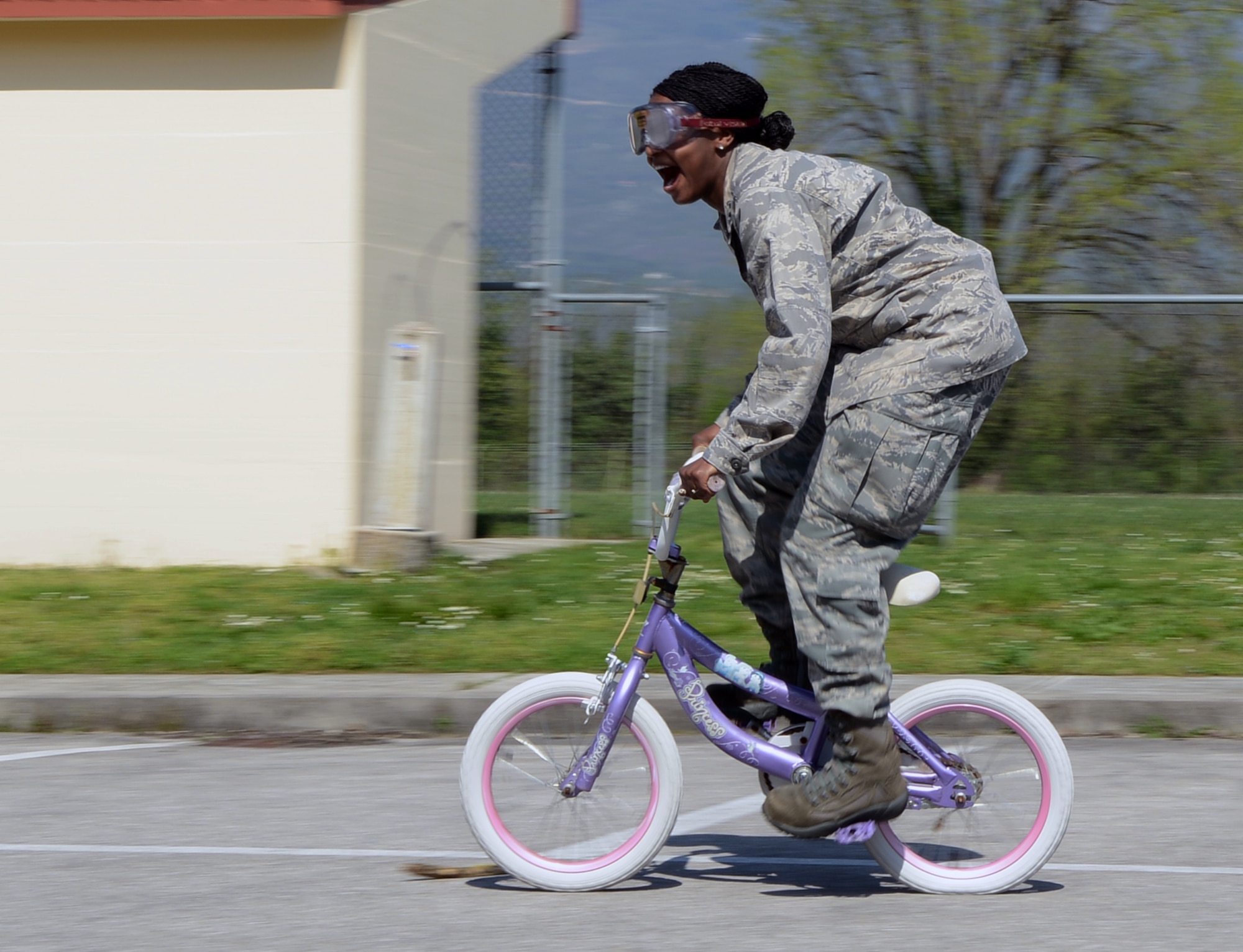 Capt. Ayana Tuchscherer, 31st Logistics Readiness Squadron deployment and distribution flight commander, rides a bike during a “drunk goggle” race at the 2013 Motorcycle Rodeo April 25, 2013, at Aviano Air Base, Italy. The race allowed riders to experience what riding under the influence of alcohol would be like due to the distortion from the goggles. (U.S Air Force photo/Senior Airman Michael Battles)
