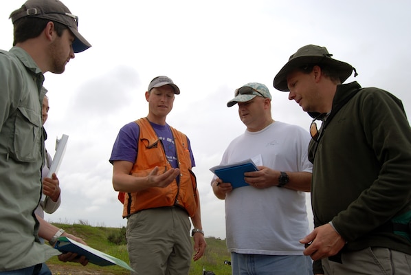 Jacob Berkowitz (wearing vest), a research soils scientist at the Corps' Engineer Research and Development Center in Vicksburg, Miss., conducts a "bounce test" of soil during a March 20, 2013, training site visit with (left to right) Daniel Orr, California Department of Fish and Wildlife, and Robert Smith and Antal Szijj, of the Corps' Los Angeles District.