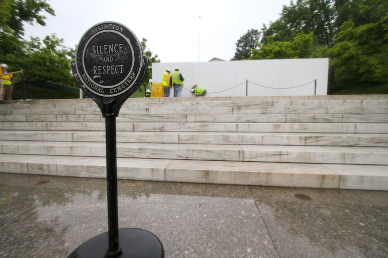 ARLINGTON, Va. – Contractors install white fencing  at the John F. Kennedy Eternal Flame at Arlington National Cemetery April 29, 2013. The fencing will block the public’s view of the flame while contractors install burners, an igniter and new gas and air lines. Work on the burner itself will take about three weeks to complete. (U.S. Army photo/Patrick Bloodgood)