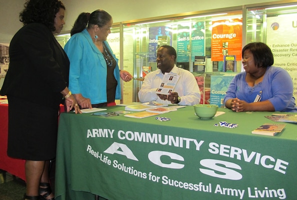 Huntsville Center Equal Employment Opportunity employees, Sonja Rice and Angela Morton gather information from Redstone Arsenal Army Community Service Sexual Assault and Domestic Violence Program victim advocates Perrar Joseph and Jeronica Frierson,at the Center Apr. 23.