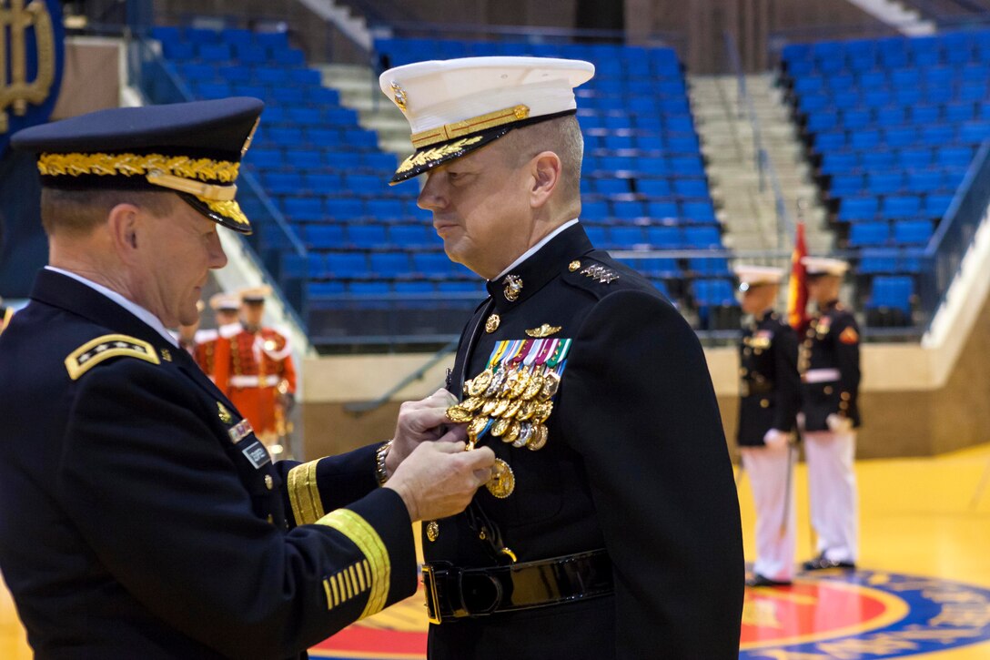 Army Gen. Martin E. Dempsey, chairman of the Joint Chiefs of Staff, left, pins a Defense Distinguished Service Medal on Marine Corps Gen. John R. Allen, right, during Allen's retirement ceremony at the U.S. Naval Academy in Annapolis, Md., April 29, 2013.