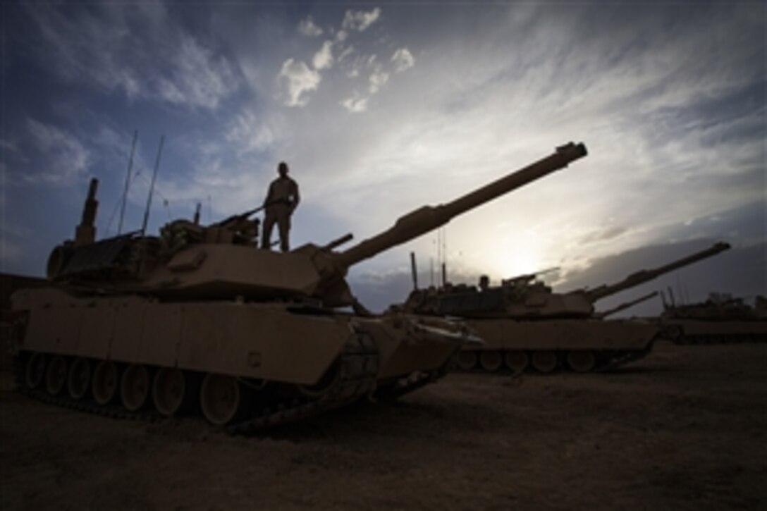 U.S. Marine Corps Cpl. Joseph Ordille pauses while conducting function checks on an M1A1 Abrams tank at Camp Shir Ghazay in the Helmand province of Afghanistan on April 25, 2013.  Ordille is assigned to Delta Company, 1st Tank Battalion, Regimental Combat Team 7.  