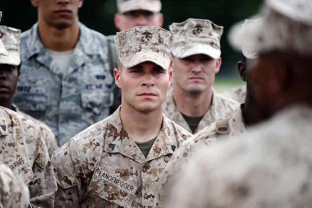 Marine Corps Cpl. Ryan Langenegger, 4th Engineer Equipment Maintenance Company from Omaha, Neb., listens to his instructor as he stands with fellow students attending the U.S. Marine Corps Corporals Leadership Course at Offutt Air Force Base, Neb., July 17, 2013. Marines from across the U.S. and several Airmen stationed at Offutt took part in the first Corporals Leadership Course hosted by the 55th Wing July 13-27. 