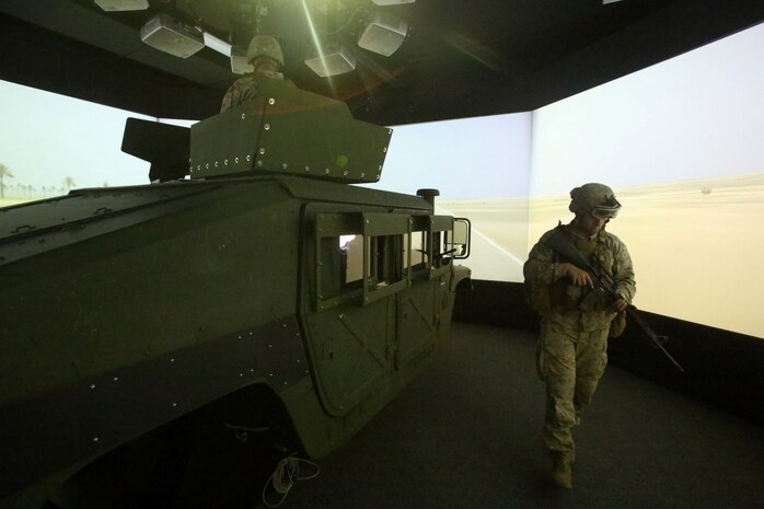 MARINE CORPS BASE CAMP PENDLETON, Calif. – Lance Cpl. Kyle Kirby, rifleman, 1st Combined Anti-Armor Team, 2nd Battalion, 5th Marine Regiment, and native of Chicago, patrols around his team’s vehicle during a simulated convoy in the Combat Convoy Simulator here, July 25, 2013. The CCS provides an immersive training environment for both convoy operations training and command and control procedures for vehicle and convoy commanders in tactical scenarios. The CCS places Marines in a realistic environment and allows for repetition, review and critique while saving time, maintenance, ammunition, weapons and range facilities.